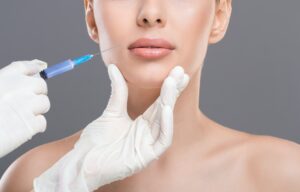 Young woman receiving facial skin lifting injections